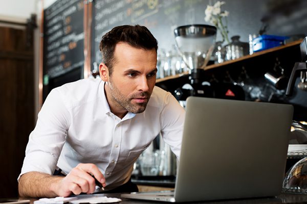 Man looking a laptop on Sage Intacct page